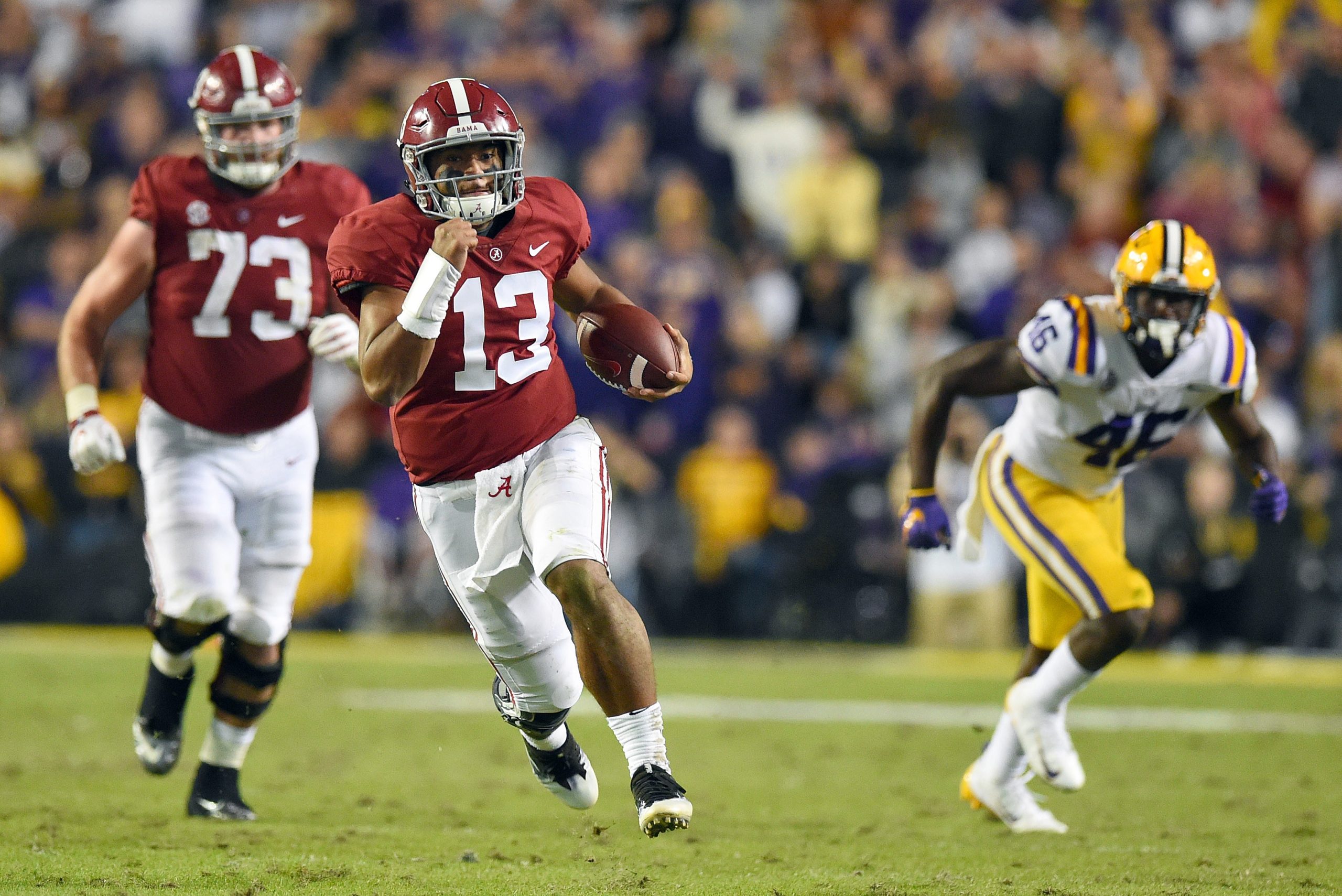 Nov 3, 2018; Baton Rouge, LA, USA; Alabama Crimson Tide quarterback Tua Tagovailoa (13) carries for a 44-yard touchdown against the LSU Tigers during the third quarter at Tiger Stadium. Photo Credit: John David Mercer-USA TODAY Sports