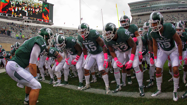 Tyler O'Connor (7) leads his team onto the field prior to a game against the Indiana Hoosiers at Spartan Stadium. O'Conner will take over the starting QB role. Photo Credit: Mike Carter-USA TODAY Sports