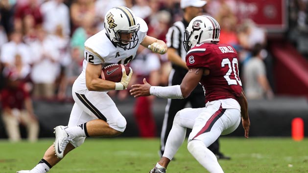 Sep 26, 2015; Columbia, SC, USA; UCF Knights wide receiver Blake Tiralosi (12) makes a catch and is stopped by South Carolina Gamecocks safety T.J. Gurley (20) during the second half at Williams-Brice Stadium. Mandatory Credit: Jim Dedmon-USA TODAY Sports