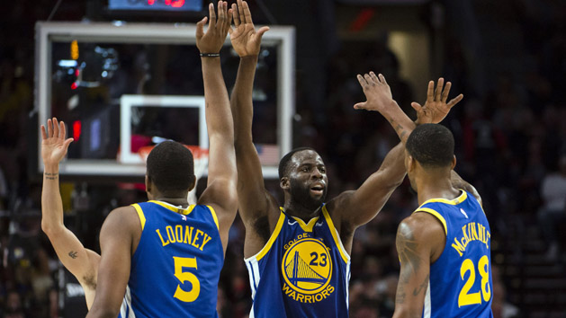 May 18, 2019; Portland, OR, USA; Golden State Warriors forward Draymond Green (23) gives high-fives to teammates center Kevon Looney (5) and forward Alfonzo McKinnie (28) during the second half in game three of the Western conference finals of the 2019 NBA Playoffs at Moda Center. The Golden State Warriors beat the Portland Trail Blazers 110-99. Photo Credit: Troy Wayrynen-USA TODAY Sports