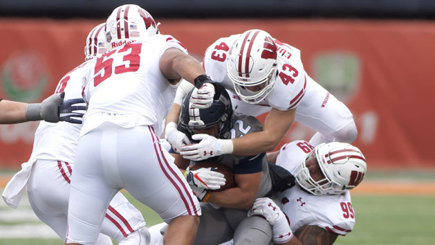Oct 28, 2017; Champaign, IL, USA; Illinois Fighting Illini running back Kendrick Foster (22) is tackled by Wisconsin Badgers linebacker Ryan Connelly (43) and nose tackle Olive Sagapolu (99) during the fourth quarter at Memorial Stadium. Photo Credit: Mike Granse-USA TODAY Sports